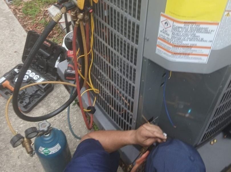 Stuart Technician repairing outside HVAC unit.