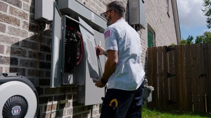 Stuart electrical technician opening the electrical panel to inspect.
