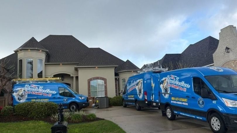 Stuart team ready to help homeowner with emergency services with three vans in front of home.