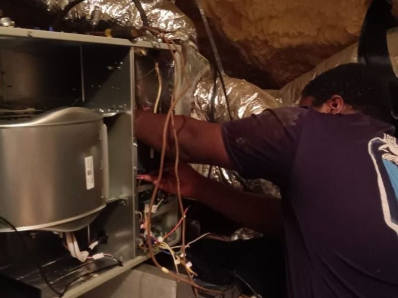 Technician repairing HVAC for better indoor air quality.