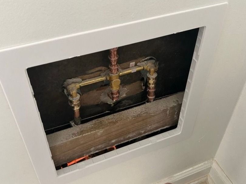 Plumber checking plumbing system to try to pin-point leak.
