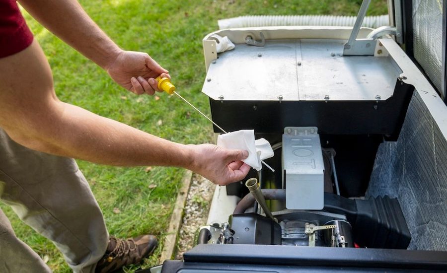 Electrician doing maintenance on generator outside of a home